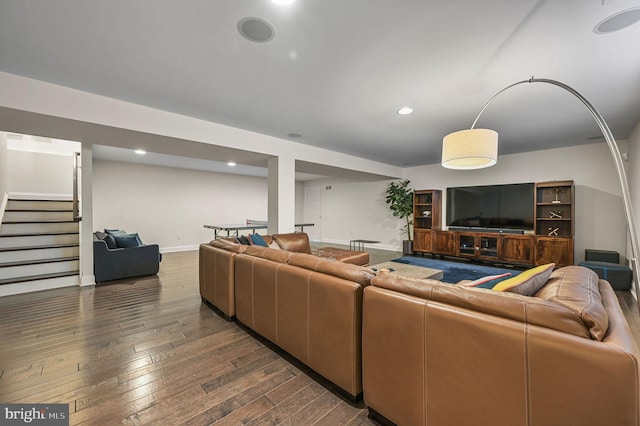living area with baseboards, stairs, recessed lighting, and wood-type flooring