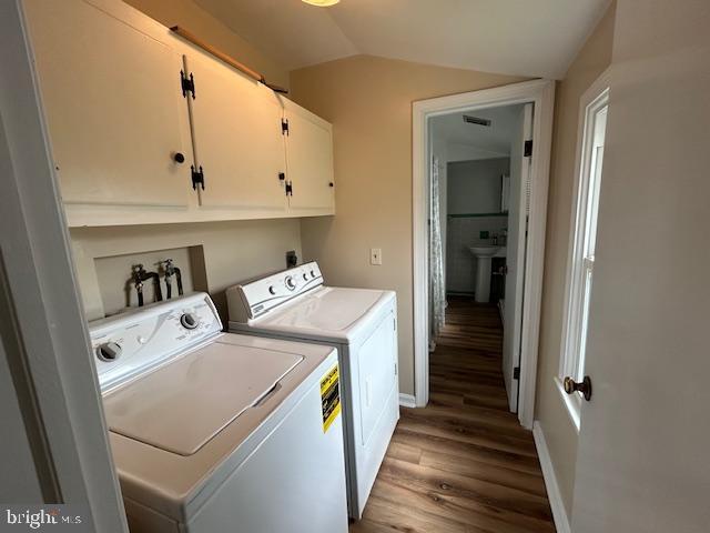 1095 Senseny Rd, Berryville, VA 22611 - washroom with visible vents, cabinet space, wood finished floors, baseboards, and separate washer and dryer
