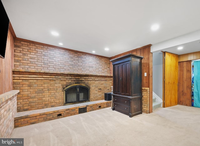 458 Silver Ct, Westminster, MD 21158 - unfurnished living room with a brick fireplace, carpet, recessed lighting, wood walls, and stairway