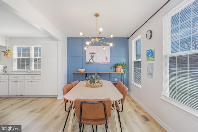 219 Hitching Post Dr, Bel Air, MD 21014 - dining space featuring a chandelier, light wood finished floors, and baseboards