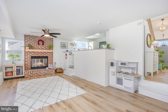 219 Hitching Post Dr, Bel Air, MD 21014 - living area featuring a ceiling fan, light wood finished floors, a fireplace, and baseboards
