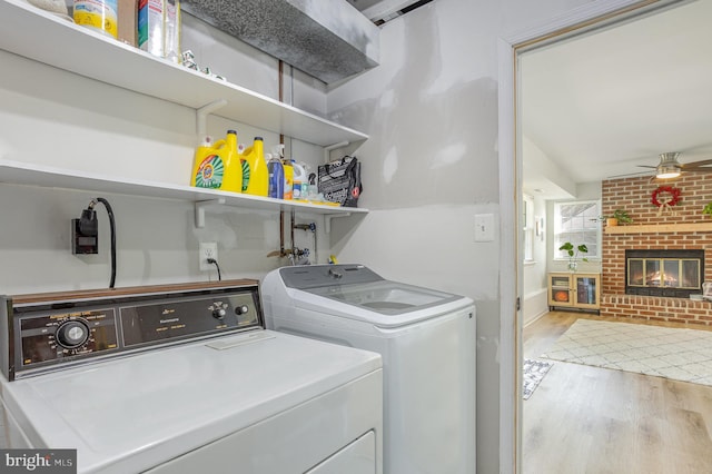 219 Hitching Post Dr, Bel Air, MD 21014 - laundry room with separate washer and dryer, a ceiling fan, wood finished floors, and a brick fireplace