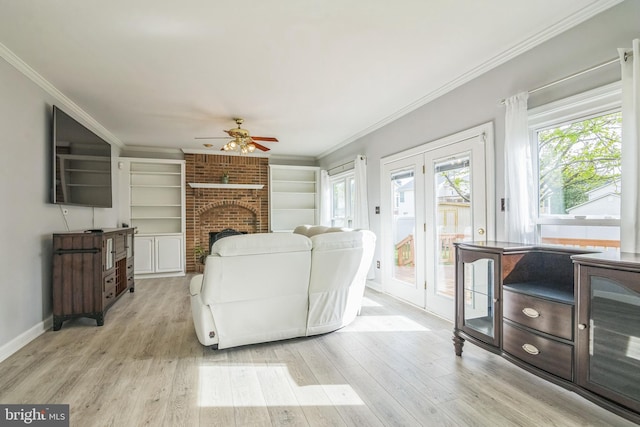 living room featuring ornamental molding, a ceiling fan, and light wood-style flooring