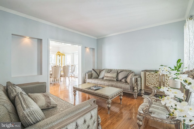 living room with ornamental molding and hardwood / wood-style flooring