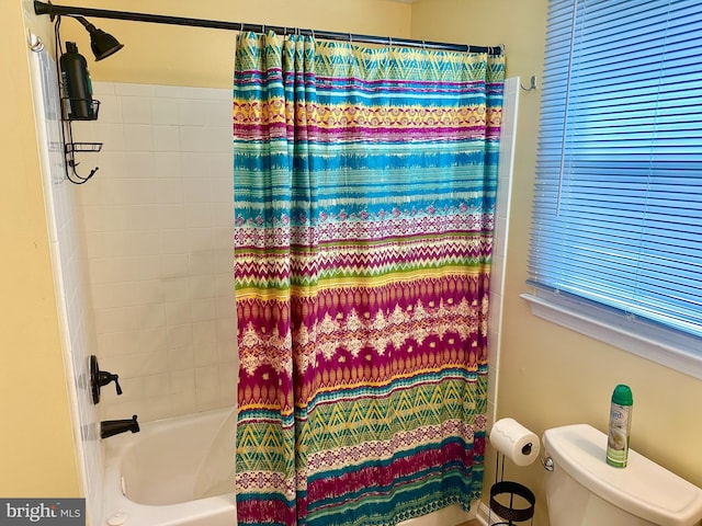 bathroom with shower / tub combo and toilet