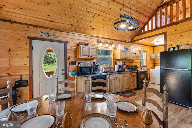 dining area with light wood finished floors, high vaulted ceiling, wood walls, washer / dryer, and wood ceiling