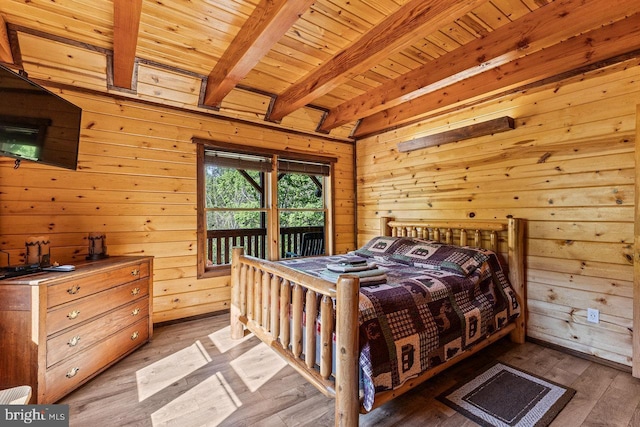 bedroom featuring wooden walls, access to outside, beam ceiling, wood finished floors, and wood ceiling