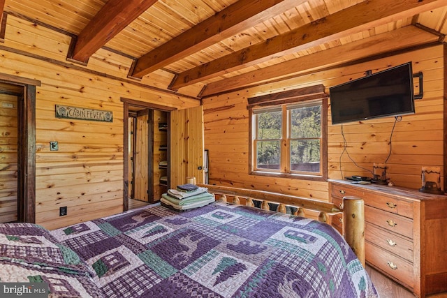 bedroom featuring wood walls, wooden ceiling, and beam ceiling