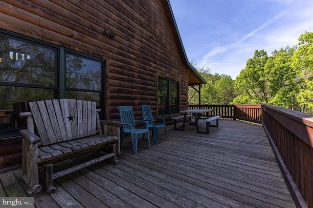 wooden deck with outdoor dining space