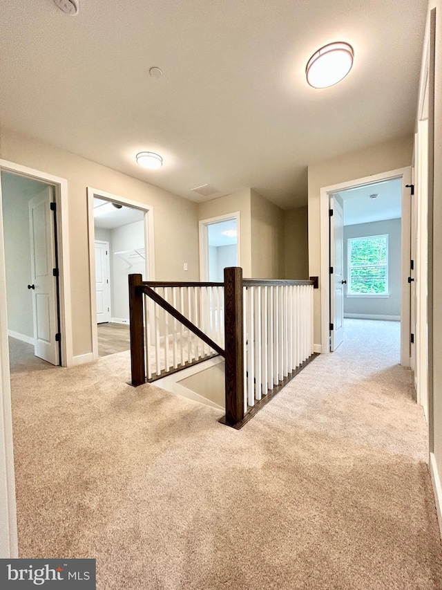 4655 Mountain Rd, Pasadena, MD 21122 - hallway featuring an upstairs landing, carpet flooring, and baseboards