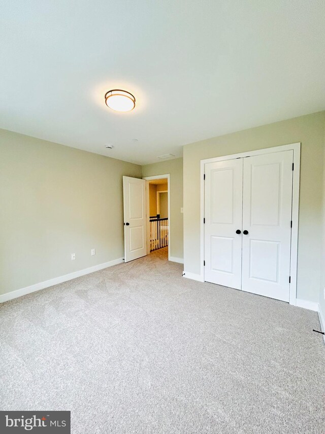 4655 Mountain Rd, Pasadena, MD 21122 - unfurnished bedroom featuring carpet floors, baseboards, and a closet