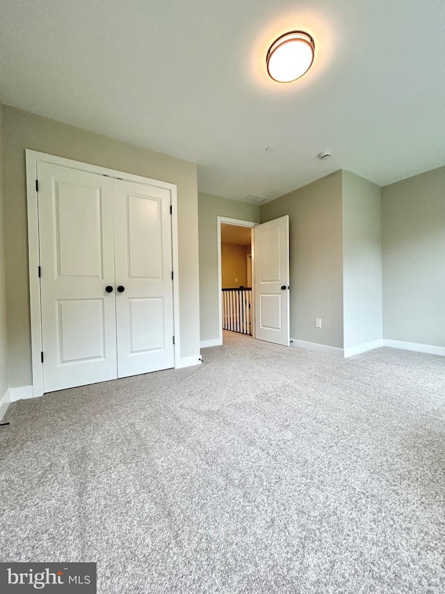 4655 Mountain Rd, Pasadena, MD 21122 - unfurnished bedroom featuring baseboards, carpet flooring, and a closet