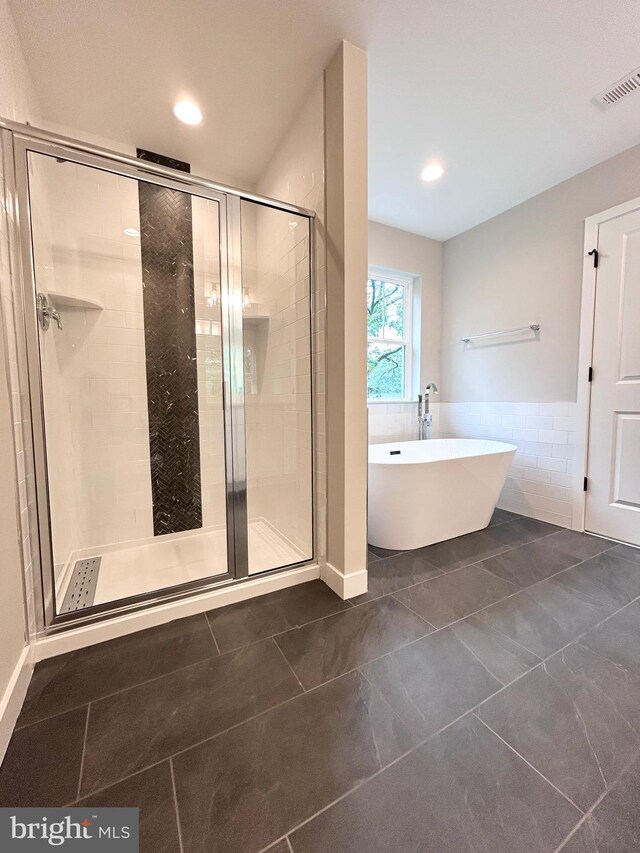 4655 Mountain Rd, Pasadena, MD 21122 - bathroom featuring a stall shower, a soaking tub, tile patterned flooring, recessed lighting, and tile walls