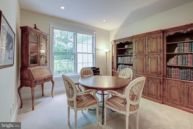 dining room with light carpet and recessed lighting
