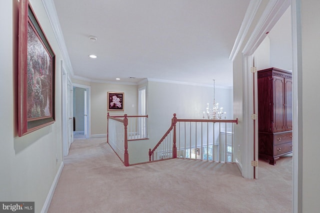 corridor featuring an upstairs landing, light carpet, a chandelier, crown molding, and baseboards