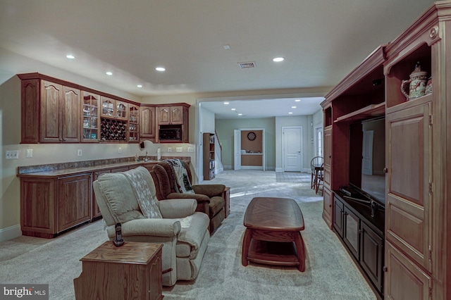 living room featuring light carpet, recessed lighting, wet bar, and baseboards