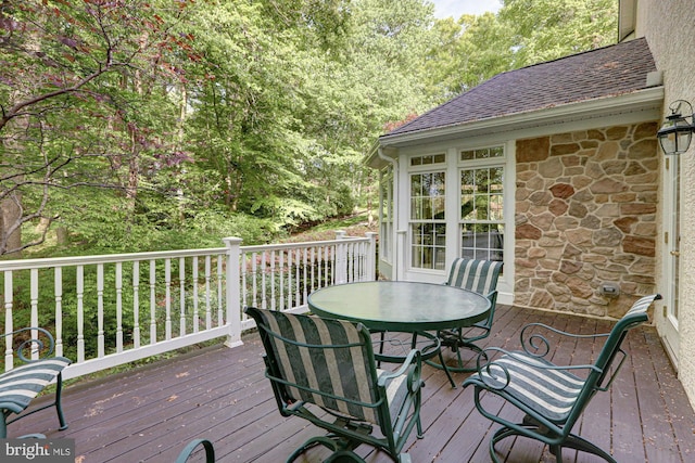 wooden terrace with outdoor dining area