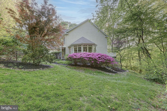view of home's exterior featuring a lawn