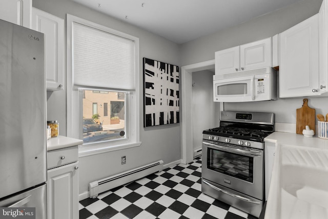 kitchen featuring stainless steel appliances, tile patterned floors, white cabinetry, baseboard heating, and light countertops
