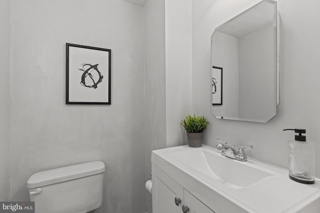 half bath featuring toilet and vanity