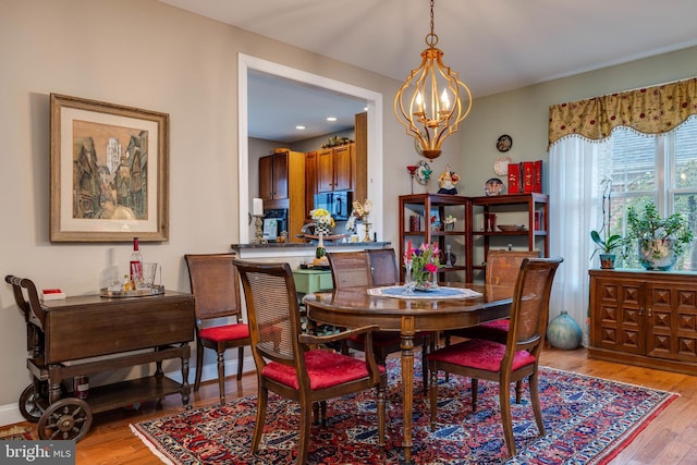 617 Redbud Ln, Woodstock, VA 22664 - dining area featuring baseboards, light wood-type flooring, and a notable chandelier