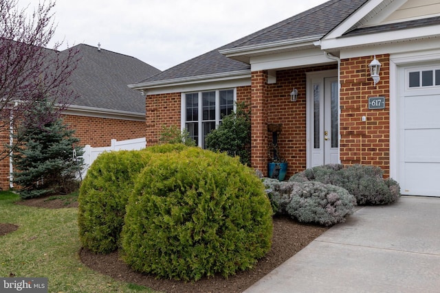 617 Redbud Ln, Woodstock, VA 22664 - property entrance with brick siding, a shingled roof, and a garage