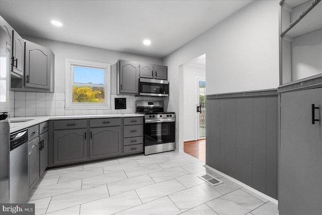 kitchen featuring gray cabinets, visible vents, and appliances with stainless steel finishes
