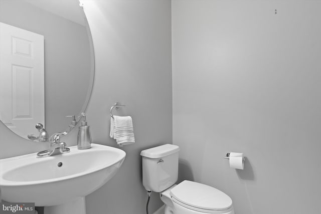 half bath with a sink and toilet