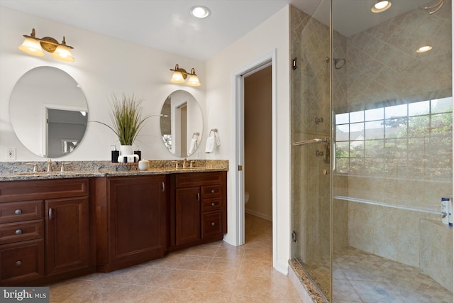 full bathroom with a shower stall, toilet, double vanity, tile patterned floors, and recessed lighting