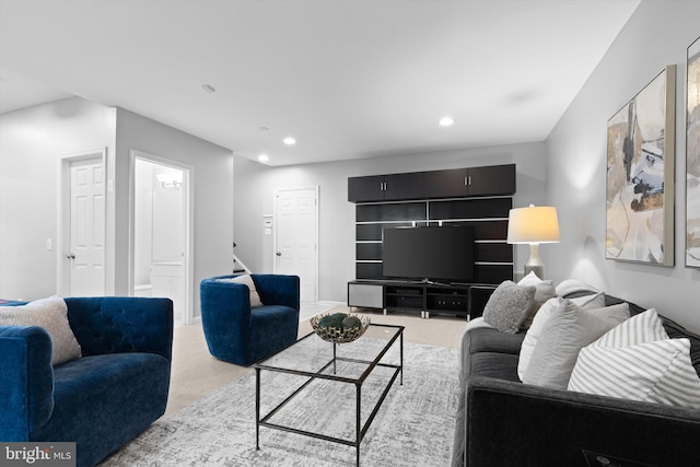 living area with recessed lighting and light colored carpet