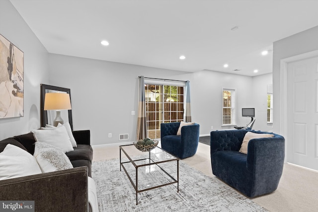 carpeted living room with recessed lighting and baseboards