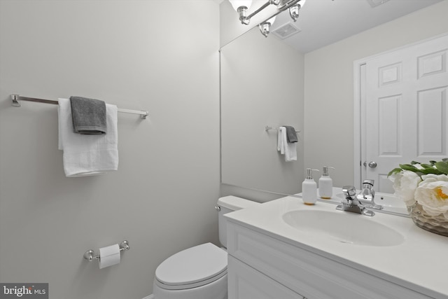 bathroom featuring toilet and vanity