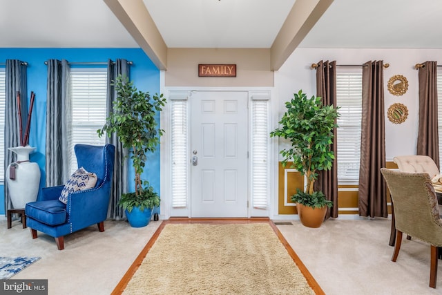 foyer entrance featuring carpet floors