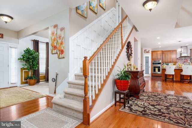 entrance foyer with recessed lighting, stairway, and light wood-type flooring