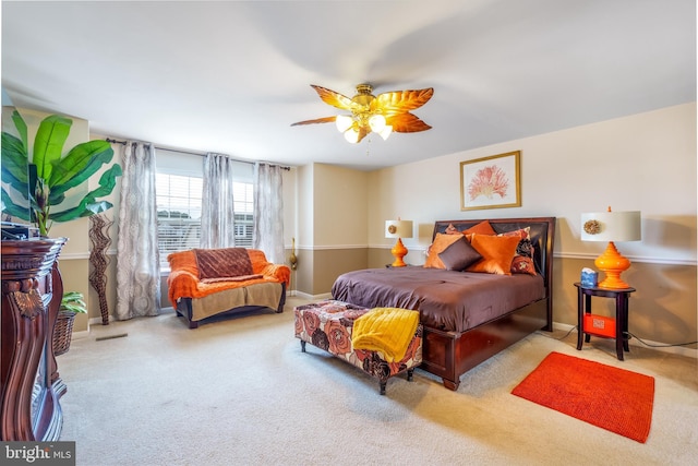 bedroom with visible vents, baseboards, a ceiling fan, and carpet flooring