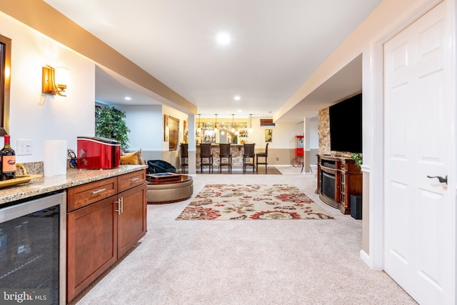 living room with a bar, recessed lighting, light colored carpet, and wine cooler
