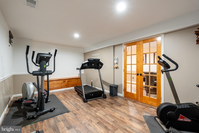 exercise room with french doors, baseboards, wood finished floors, and visible vents