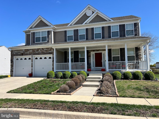 view of front facade featuring a porch, stone siding, a garage, and concrete driveway