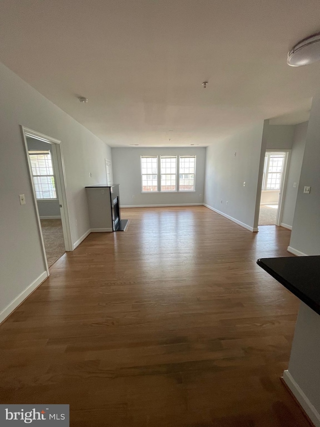 42480 Rockrose Sq Unit 202, Brambleton, VA 20148 - unfurnished living room with dark wood finished floors and baseboards
