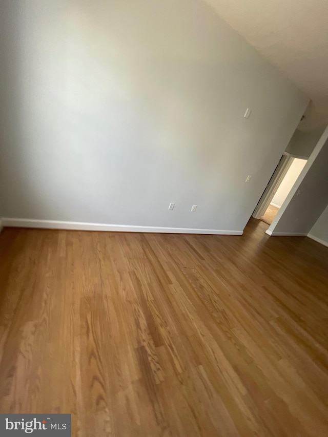 42480 Rockrose Sq Unit 202, Brambleton, VA 20148 - empty room with baseboards and wood finished floors