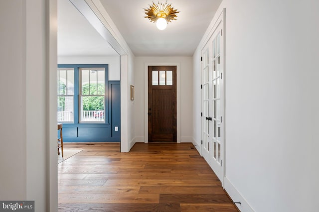 entrance foyer featuring healthy amount of natural light, wood finished floors, and baseboards