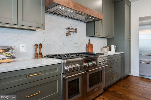 kitchen featuring range with two ovens, premium range hood, dark wood finished floors, gray cabinets, and backsplash