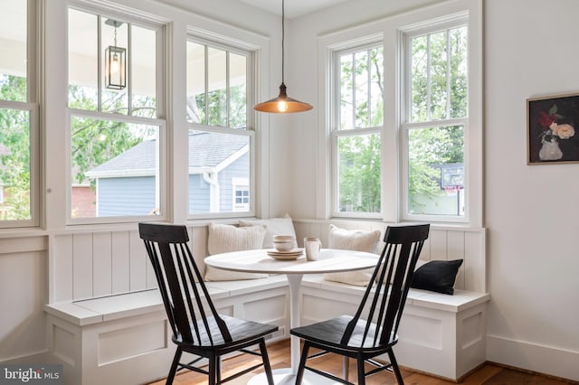 dining area with breakfast area, light wood-style floors, and baseboards