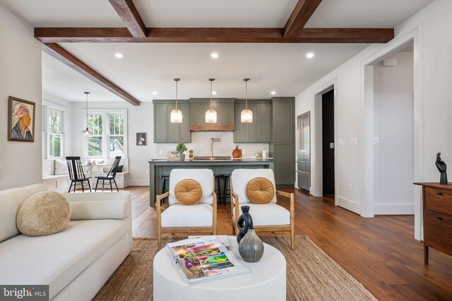 living area featuring dark wood-style flooring, recessed lighting, beamed ceiling, and baseboards