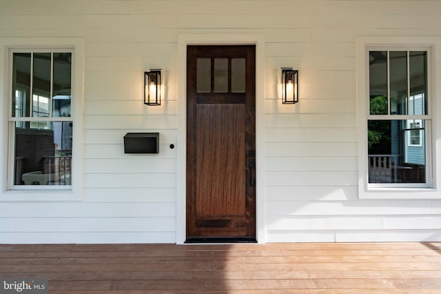 view of exterior entry featuring a porch