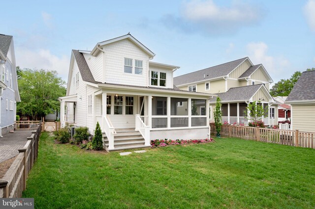 back of property with a sunroom