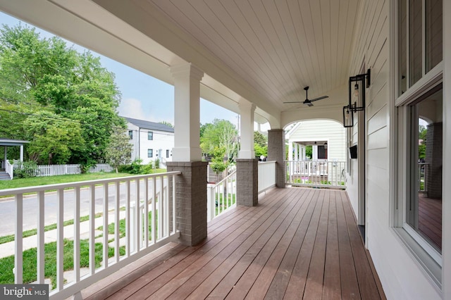 wooden deck with covered porch and a ceiling fan