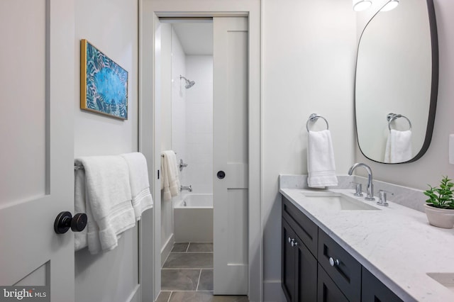 bathroom with double vanity and washtub / shower combination