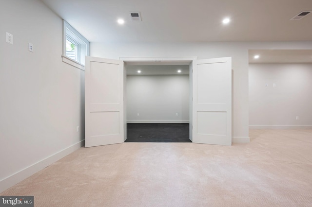 below grade area with recessed lighting, carpet floors, and baseboards