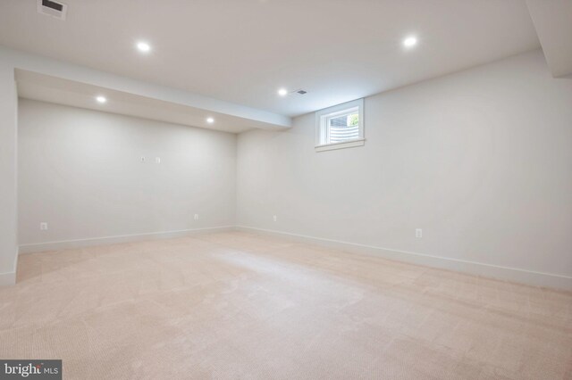 basement with recessed lighting, baseboards, and light colored carpet
